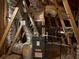 HVAC equipment in the attic with foil-wrapped ductwork and wood beams at 725 Valley Glen Dr, Dacula, GA 30019