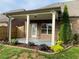 Covered patio overlooking lush landscaped backyard with wooden privacy fence at 725 Valley Glen Dr, Dacula, GA 30019