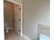 Clean bathroom with a white toilet and tile accents near the tub at 725 Valley Glen Dr, Dacula, GA 30019