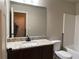 Bathroom features granite countertops, dark wood cabinets, and shower tub at 725 Valley Glen Dr, Dacula, GA 30019