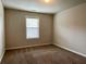 Neutral bedroom with tan carpet and one window for natural light at 725 Valley Glen Dr, Dacula, GA 30019