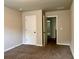 Neutral bedroom features a plush carpet, walk-in closet, and ensuite entrance at 725 Valley Glen Dr, Dacula, GA 30019