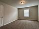 Cozy bedroom with neutral carpet, window, and trim at 725 Valley Glen Dr, Dacula, GA 30019