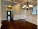 This dining room features beautiful millwork, a modern light fixture and an arched pass-through at 725 Valley Glen Dr, Dacula, GA 30019