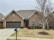 Charming brick home with well-manicured lawn and two-car garage at 725 Valley Glen Dr, Dacula, GA 30019