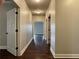 Hallway featuring dark hardwood floors and white trim at 725 Valley Glen Dr, Dacula, GA 30019