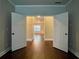 Hallway featuring dark hardwood floors and french doors at the end at 725 Valley Glen Dr, Dacula, GA 30019
