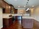 Beautiful kitchen featuring dark cabinets, stainless steel appliances and granite countertops at 725 Valley Glen Dr, Dacula, GA 30019