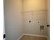 Empty laundry room featuring tile flooring, neutral paint, and utility hookups at 725 Valley Glen Dr, Dacula, GA 30019