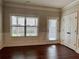 Bright living room featuring trim molding and a large window at 725 Valley Glen Dr, Dacula, GA 30019