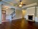 Open-concept living area features a fireplace, hardwood floors, and natural light at 725 Valley Glen Dr, Dacula, GA 30019