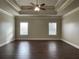 Spacious main bedroom featuring a tray ceiling and two windows at 725 Valley Glen Dr, Dacula, GA 30019