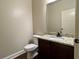 Powder room featuring hardwood floors and a dark vanity with granite countertop at 725 Valley Glen Dr, Dacula, GA 30019