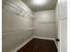 Walk-in closet featuring multiple wire shelves and dark hardwood floors at 725 Valley Glen Dr, Dacula, GA 30019