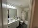 Well-lit bathroom featuring a single sink vanity and a shower-tub combo with neutral shower curtain at 136 Swindon Dr, Mcdonough, GA 30253