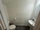 Neat half-bathroom includes pedestal sink and modern fixtures at 136 Swindon Dr, Mcdonough, GA 30253