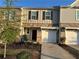 Charming townhome with a well-manicured lawn and attached garage at 136 Swindon Dr, Mcdonough, GA 30253