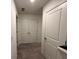 Upstairs hallway with closet space and neutral carpeting at 136 Swindon Dr, Mcdonough, GA 30253