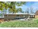 Spacious backyard featuring a brick home, patio, manicured lawn, and covered outdoor seating at 2569 Woodhill Ln, Atlanta, GA 30344