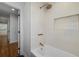 Renovated bathroom showcasing gold fixtures, white tile, and a niche within the shower wall, offering a clean, modern design at 2569 Woodhill Ln, Atlanta, GA 30344