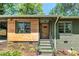 Charming home with brickwork, an inviting wood door, and landscaped front yard at 2569 Woodhill Ln, Atlanta, GA 30344