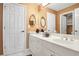 Bright bathroom featuring a double sink vanity, decorative mirrors, and white paneled doors at 3902 Butterstream Nw Way, Kennesaw, GA 30144