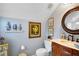 Charming bathroom with a furniture style vanity, decorative mirror, and blue walls at 3902 Butterstream Nw Way, Kennesaw, GA 30144