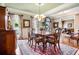 Formal dining room with elegant chandelier, floral drapes and ample seating for entertaining at 3902 Butterstream Nw Way, Kennesaw, GA 30144