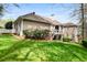 Exterior view of the home featuring a well-maintained lawn, a deck, and mature landscaping at 3902 Butterstream Nw Way, Kennesaw, GA 30144