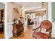 Bright foyer with hardwood floors, decorative chest of drawers and an antique accent chair at 3902 Butterstream Nw Way, Kennesaw, GA 30144