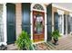 Charming front door with a decorative wreath, flanked by green ferns and windows at 3902 Butterstream Nw Way, Kennesaw, GA 30144