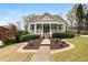 Charming home with a welcoming front porch, manicured lawn, and landscaped garden beds at 3902 Butterstream Nw Way, Kennesaw, GA 30144