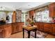 Gourmet kitchen featuring wood cabinets, granite countertops, and a kitchen island at 3902 Butterstream Nw Way, Kennesaw, GA 30144