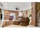 Inviting living room with brick accents, plush seating, and natural light from large windows at 3902 Butterstream Nw Way, Kennesaw, GA 30144