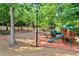 Charming community playground featuring play structures, slides, and picnic tables in a wooded setting at 3902 Butterstream Nw Way, Kennesaw, GA 30144
