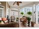 Relaxing covered porch with wicker furniture, ceiling fan, and views of the surrounding greenery at 3902 Butterstream Nw Way, Kennesaw, GA 30144