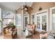 Inviting covered porch featuring wicker furniture, a ceiling fan, and a peaceful outdoor setting at 3902 Butterstream Nw Way, Kennesaw, GA 30144