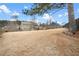 View of the grass backyard and home with a blue sky and fluffy clouds at 4535 Meadow Green Ln, Acworth, GA 30101