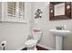 Charming powder room featuring a pedestal sink, decorative mirror, and classic fixtures at 4535 Meadow Green Ln, Acworth, GA 30101