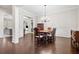 Formal dining room with hardwood floors, wainscoting, and elegant chandelier at 4535 Meadow Green Ln, Acworth, GA 30101