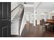 Elegant foyer featuring a grand staircase, hardwood floors, and views into the dining room at 4535 Meadow Green Ln, Acworth, GA 30101