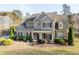 Beautiful two-story brick home with a covered porch, mature landscaping, and inviting curb appeal at 4535 Meadow Green Ln, Acworth, GA 30101