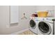 Well-organized laundry room with a front-load washer, dryer, and storage cabinet at 4535 Meadow Green Ln, Acworth, GA 30101