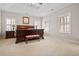 Large bedroom with tray ceiling, carpet, and plantation shutters at 4535 Meadow Green Ln, Acworth, GA 30101