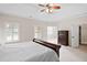 Light-filled bedroom featuring a bed, a dresser, and a ceiling fan at 4535 Meadow Green Ln, Acworth, GA 30101