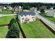 Aerial shot featuring a home with a fenced backyard and surrounding neighborhood streets at 6793 Oconee Pl, Fairburn, GA 30213