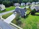 Aerial view of home featuring a two-car garage and spacious yard in a residential neighborhood at 6793 Oconee Pl, Fairburn, GA 30213