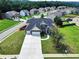 Aerial view of a two-story home with a pool and well-manicured lawn at 6793 Oconee Pl, Fairburn, GA 30213