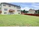 Large backyard featuring green grass, trees, and a privacy fence at 6793 Oconee Pl, Fairburn, GA 30213