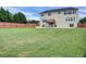 Expansive backyard featuring a wooden fence and a small deck, perfect for outdoor gatherings and play at 6793 Oconee Pl, Fairburn, GA 30213